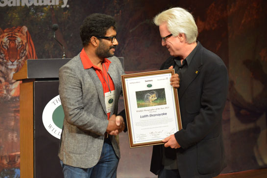 Sanctuary's Wildlife Photographer of the Year 2013 Lalith Ekanayake receives his certificate from renowned conservation photographer Steve Winter.