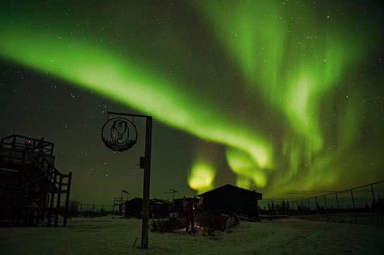The enthralling northern lights in the sky dance over a lodge in Churchill Wild where family-run lodges provide tourists with a unique wildlife safari experience, the only place in the world where you can walk on foot in the vicinity of polar bears.