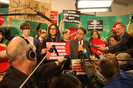 Philippine Chief Delegate Yeb Sano at COP 19 climate change press conference with Hoda Baraka of 350.org, Warsaw, Poland.