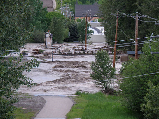 Floodwaters of the Sheep River deluge downtown Okotoks, Alberta on June 20, 2013.