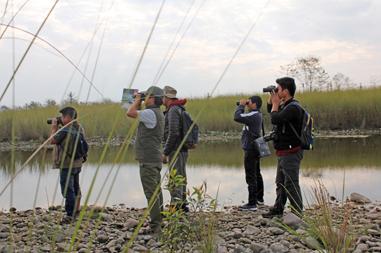 Fledgling birdwatchers and guides from the Idu Mishmi community practice their bird identification skills at the beautiful Jiya grassland on the outskirts of Roing town, Arunachal Pradesh.