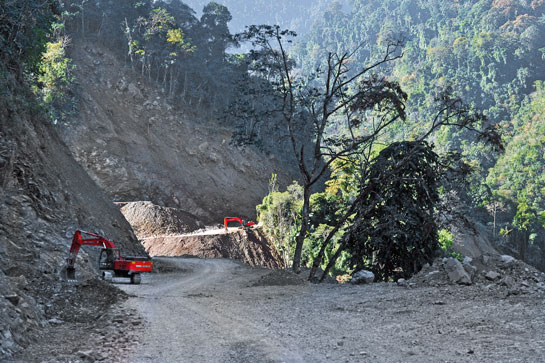 JCBs gouge the mountainside along the Siang river to make way for wide roads that planners say will connect valleys within Arunachal Pradesh.