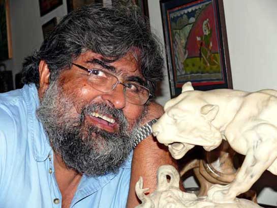 Thapar at home where he has a library of more than 1,000 books on tigers and other wildlife.