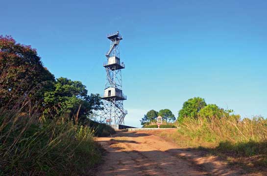 The tall, three-tiered watchtower at Sairandhri in the core area, next to which can be seen the plaque to commemorate the visit of the late Prime Minister Rajiv Gandhi to inaugurate Silent Valley National Park in September 1985.
