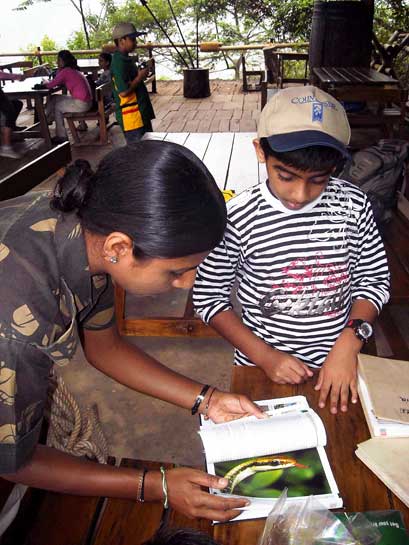 By equipping grassroots level experts and NGO volunteers with the resources to spread wildlife education, as seen in this image of a young woman using a field guide to identify a snake, the organisation is truly making a difference. By equipping grassroots level experts and NGO volunteers with the resources to spread wildlife education, as seen in this image of a young woman using a field guide to identify a snake, the organisation is truly making a difference.