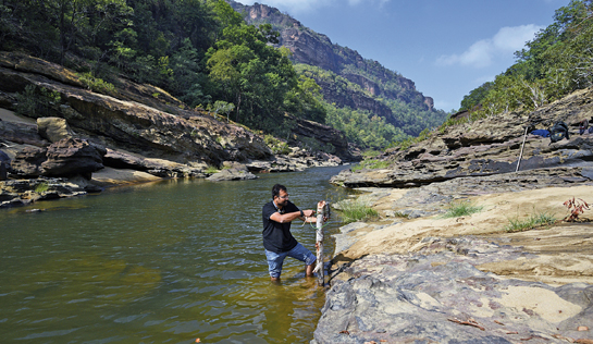 A WCT scientist deploying a camera trap to obtain photo-evidence of Eurasian otter presence in the Satpura Tiger Reserve.